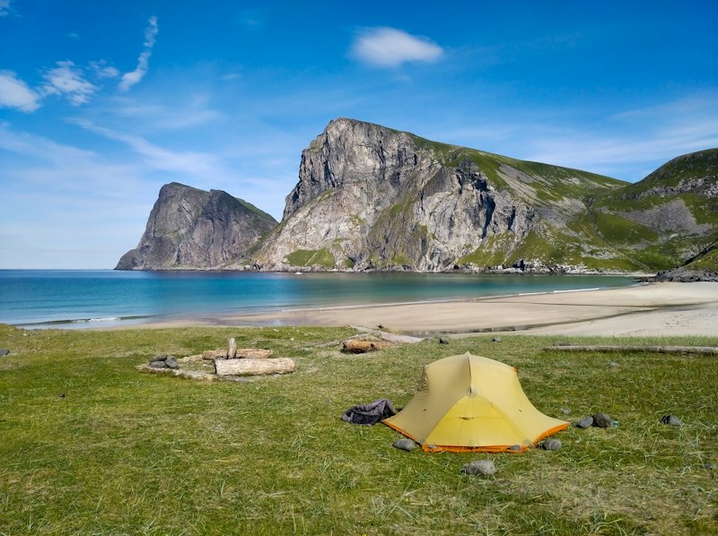 Tents pitched above Kvalvika beach in the Lofoten Islands, Norway